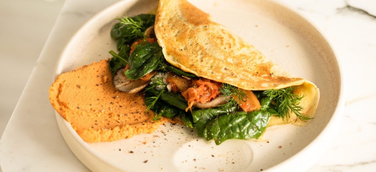 cooked omelette with leafy vegetables